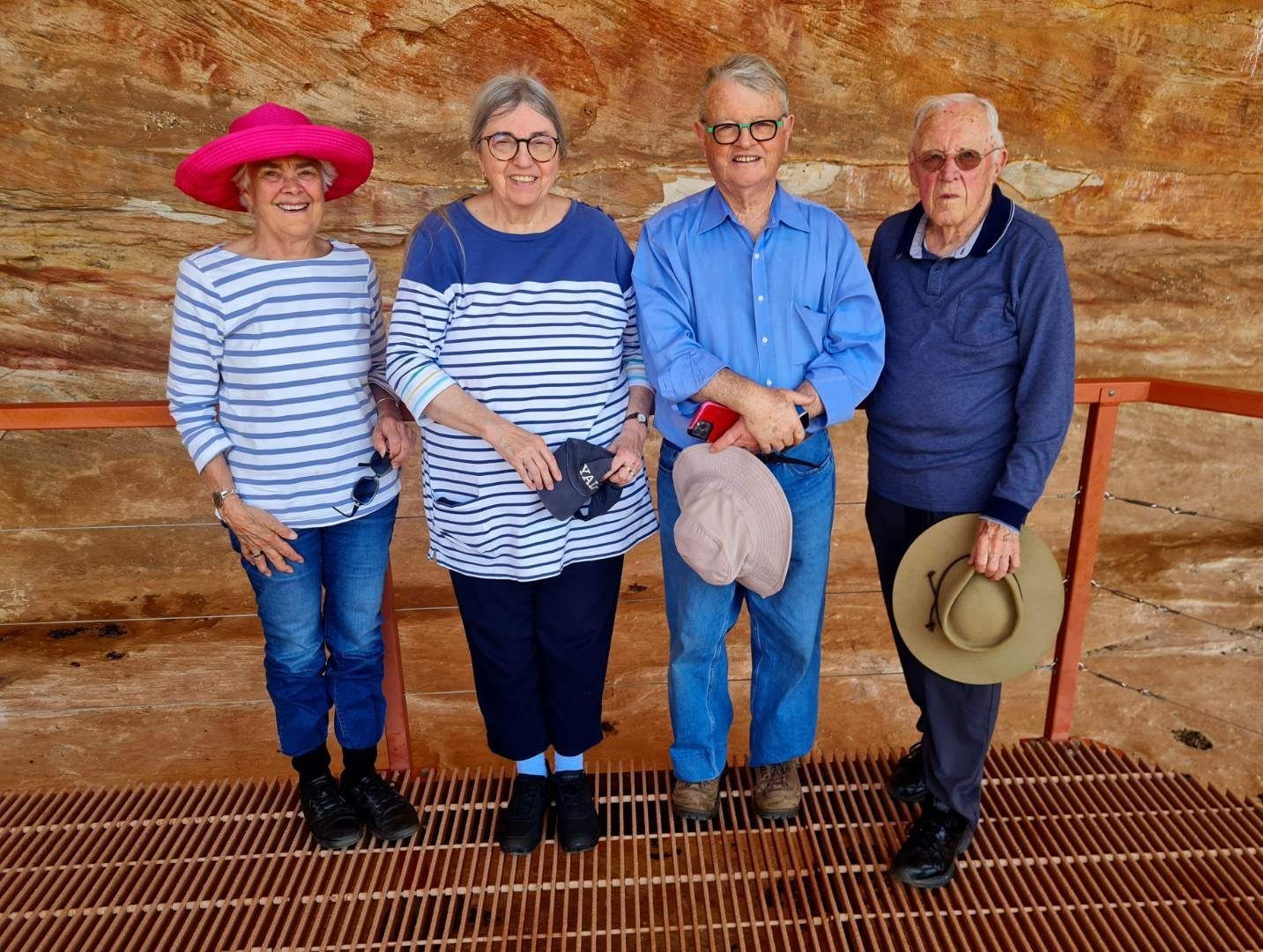 Four guests smiling on a lookout platform