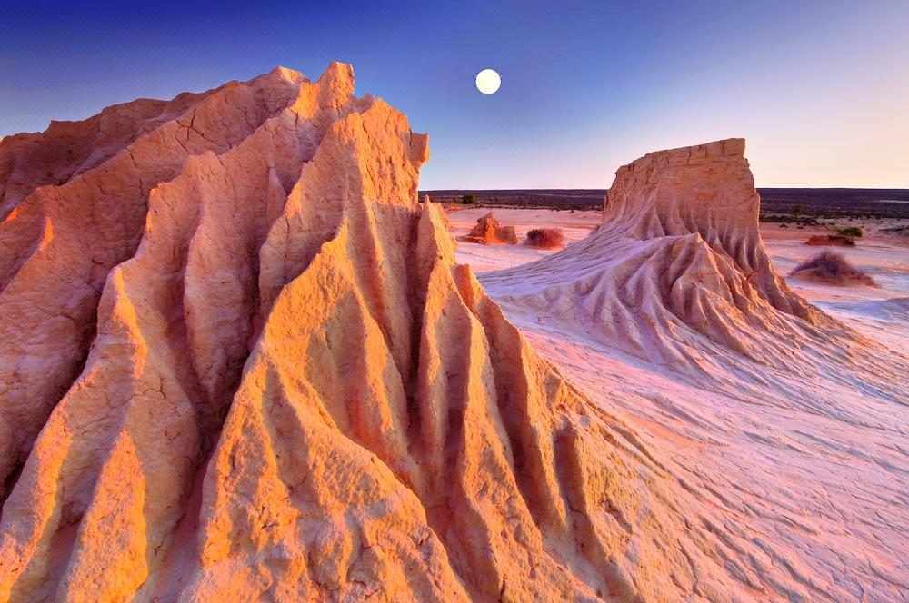 Pink-lit eroded Walls of China at Mungo with the moon rising