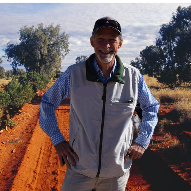 Clark, tour guide and artist, standing on red earth
